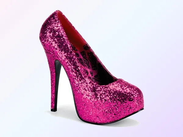 A single hot pink glitter pump with a very high black stiletto heel and a hidden front platform, seen from the side on a soft pink and lavender gradient.